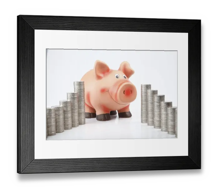 Framed Print : Piggy bank behind stacked euro coins