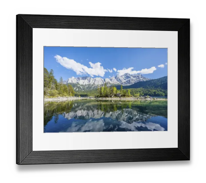 Framed Print : Zugspitze massif and Zugspitze reflected in Eibsee lake