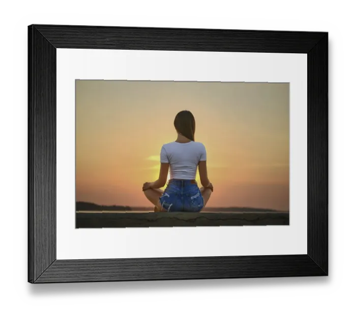 Framed Print : Rear view of a woman in meditation pose on the pier during summer sunset