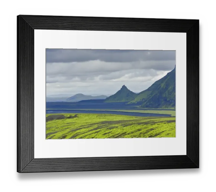 Framed Print : Hills covered with moss in front of an area with black sand and a pointed mountain Framed Print : Hills covered with moss in front of an area with black sand and a pointed mountain