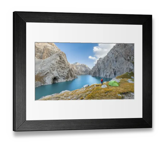 Framed Print : Young man with green tent at the turquoise mountain lake Kol Suu with rocky steep mountains Framed Print : Young man with green tent at the turquoise mountain lake Kol Suu with rocky steep mountains