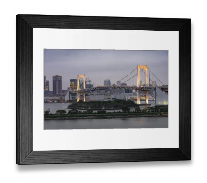 Framed Print : View of skyline with skyscrapers and illuminated Rainbow Bridge in the evening Framed Print : View of skyline with skyscrapers and illuminated Rainbow Bridge in the evening