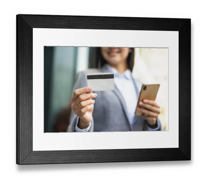 Framed Print : Smiley businesswoman with smartphone credit card outdoors Framed Print : Smiley businesswoman with smartphone credit card outdoors