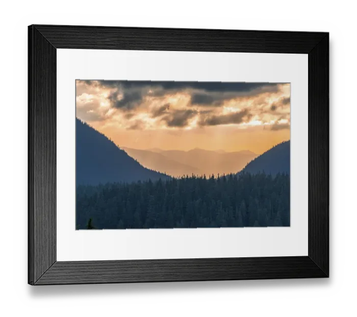 Framed Print : Hilly wooded mountain landscape at sunset with dramatic clouds