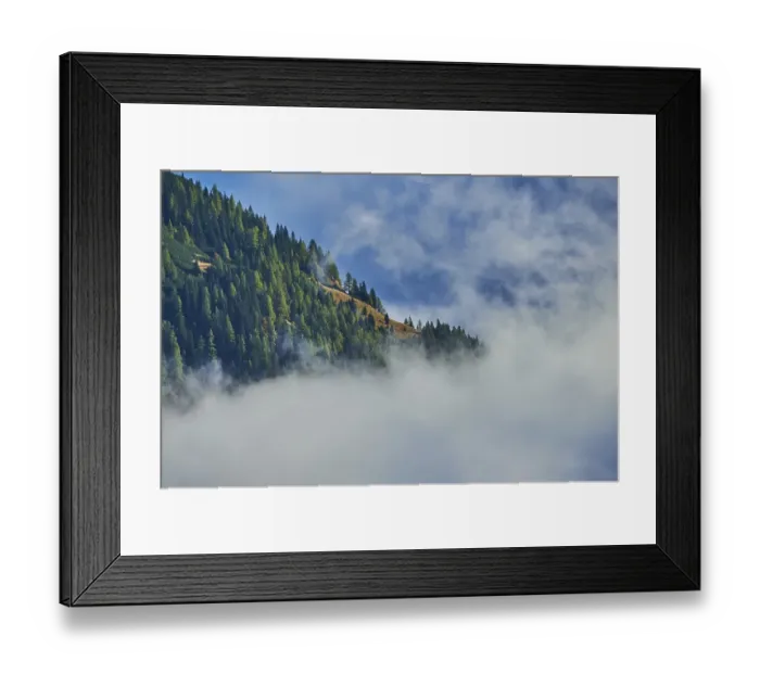 Framed Print : Clouds lying in the valley between Mountains at Hochalpenstrasse