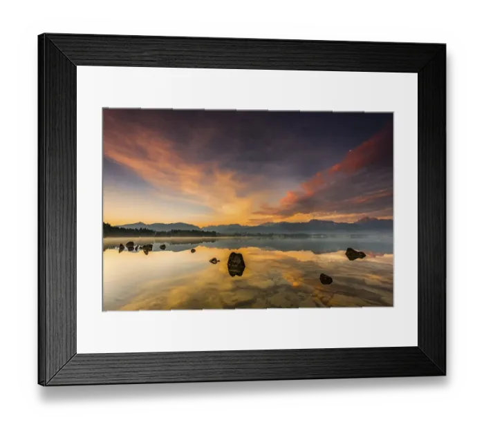 Framed Print : Forggensee with reflection of the cloudy sky and the Allgaeuer mountains in the background at sunrise Framed Print : Forggensee with reflection of the cloudy sky and the Allgaeuer mountains in the background at sunrise