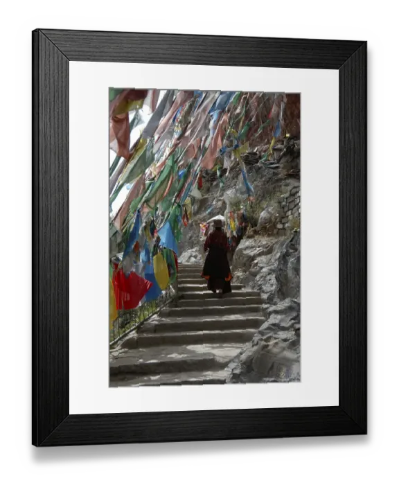 Framed Print : Tibetan Buddhism, Tibetan performing a Kora pilgrimage walk along stairs under colourful flags