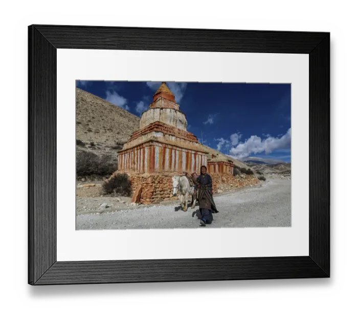 Framed Print : Woman with her horse, colourfully painted Buddhist stupa in front of mountain landscape