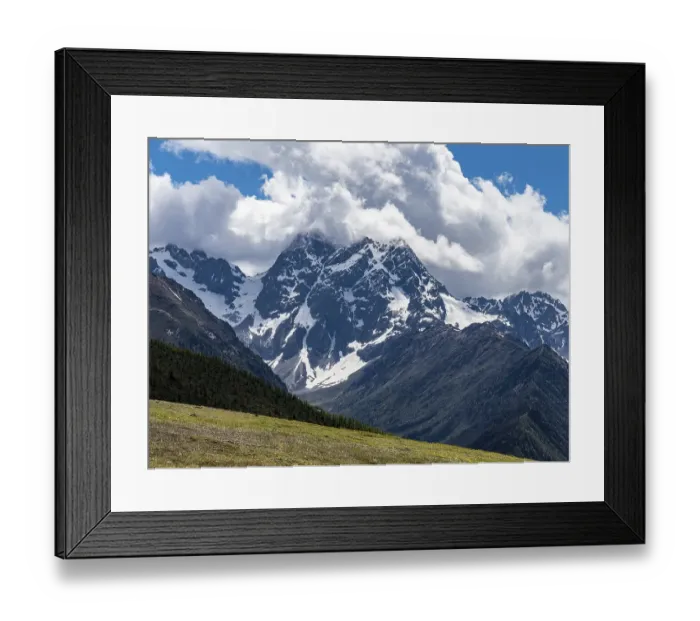 Framed Print : Mountain ranges with snow and meadows with yellow flowers in the highlands of eastern Tibet