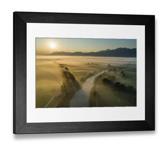 Framed Print : Aerial view of a river in front of mountains in the morning light