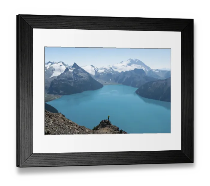 Framed Print : Young man standing on a rock, looking into the distance