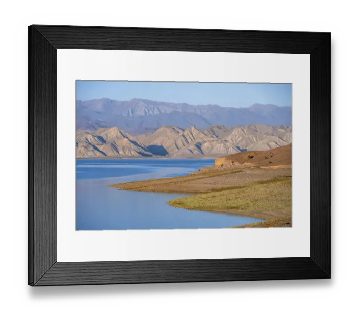 Framed Print : Blue Toktogul reservoir between dry mountain landscape