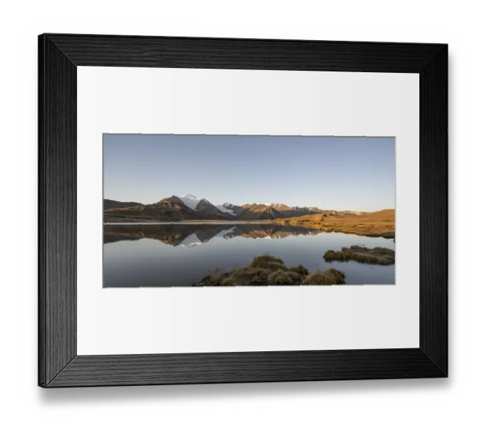 Framed Print : Glaciated mountain peaks reflected in a mountain lake at sunset Framed Print : Glaciated mountain peaks reflected in a mountain lake at sunset