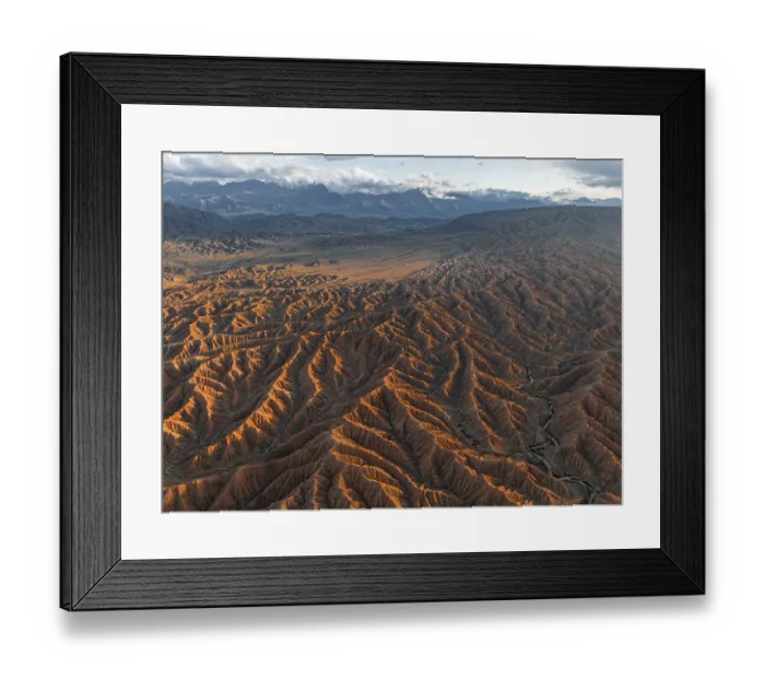 Framed Print : Landscape of eroded hills, badlands at sunset