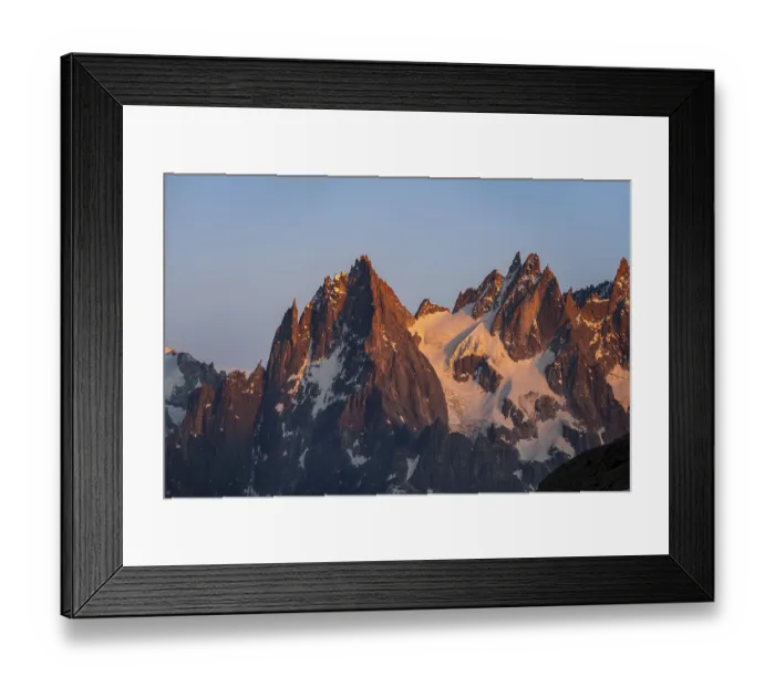 Framed Print : Rocky pointed mountain peaks at sunset