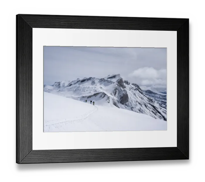 Framed Print : Group of lonely ski tourers in a snowy mountain landscape