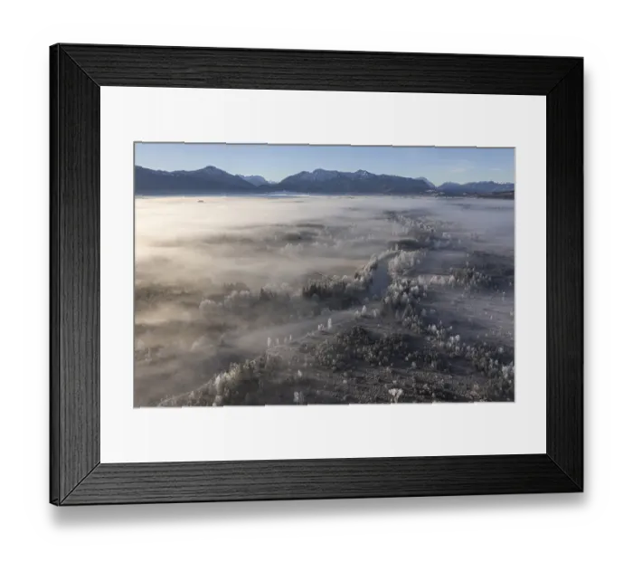 Framed Print : Aerial view of a moor landscape with river in front of mountains in winter Framed Print : Aerial view of a moor landscape with river in front of mountains in winter