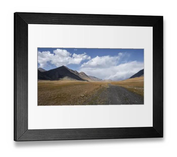 Framed Print : Gravel track on plateau, dramatic high mountains Framed Print : Gravel track on plateau, dramatic high mountains