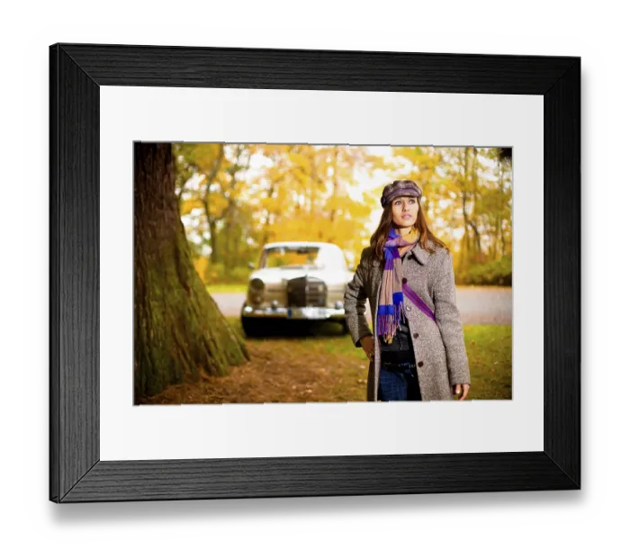 Framed Print : Young woman standing in front of a vintage car