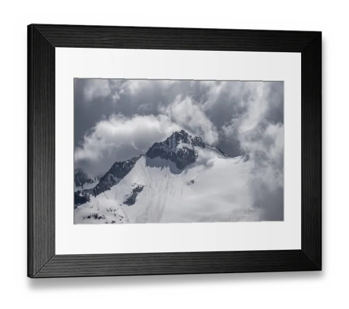 Framed Print : Dramatic clouds, rocky mountain peak with snow and glacier Waxeggkees