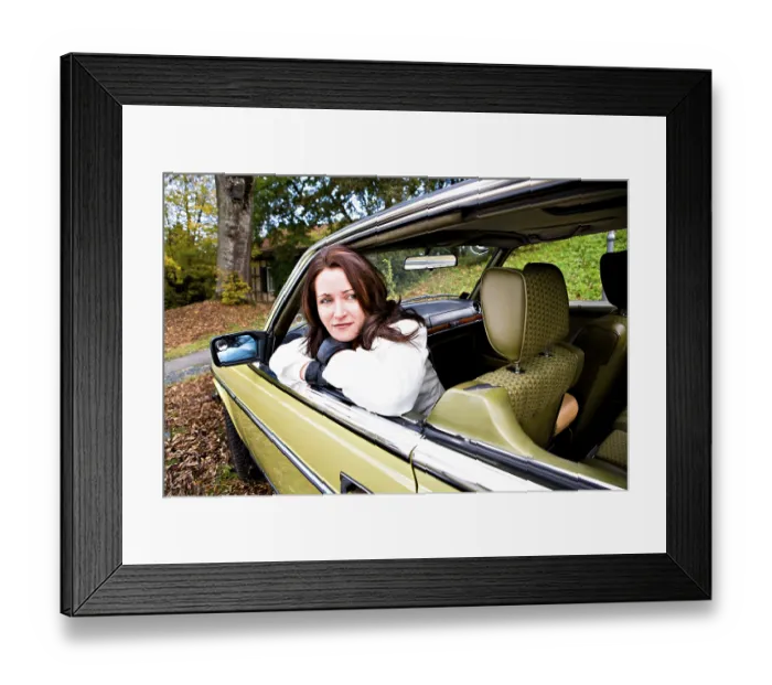 Framed Print : Young woman in a post-war classic car