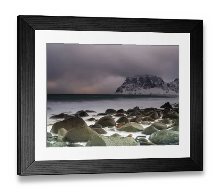 Framed Print : Rounded rocks on Utakleiv beach in a dramatic cloudy atmosphere