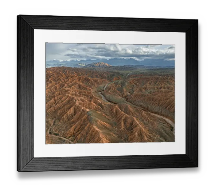 Framed Print : River bed runs through a landscape of eroded hills Framed Print : River bed runs through a landscape of eroded hills