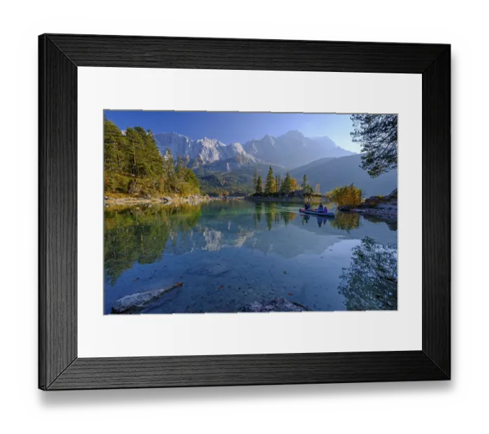 Framed Print : Canoeists on a mountain lake in front of steep mountains