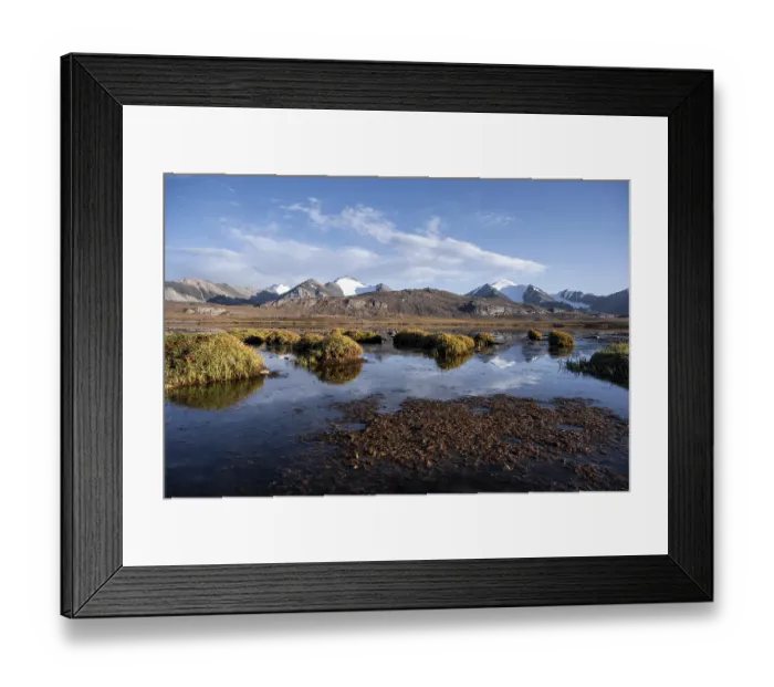 Framed Print : Mountain peaks reflected in a mountain lake