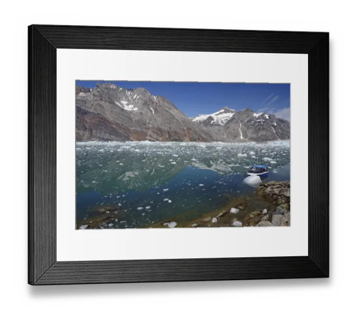Framed Print : Blue boat in a calm fjord covered with pieces of ice Framed Print : Blue boat in a calm fjord covered with pieces of ice