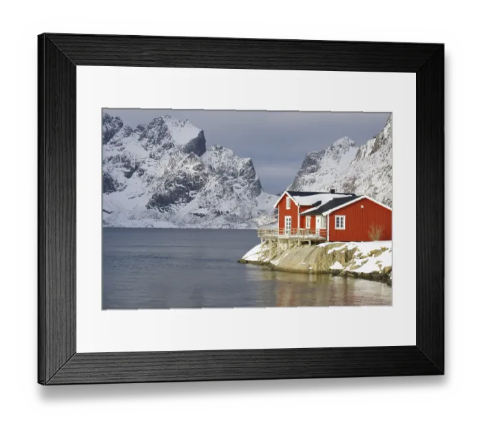 Framed Print : Wintery, Nordic landscape with red holiday home standing directly by the fjord