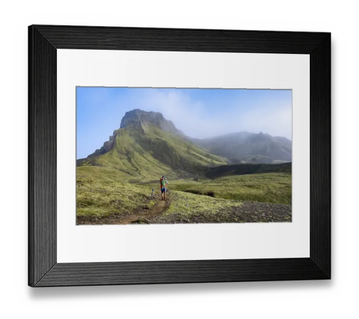 Framed Print : Hikers on trail through moss-covered mountain landscape