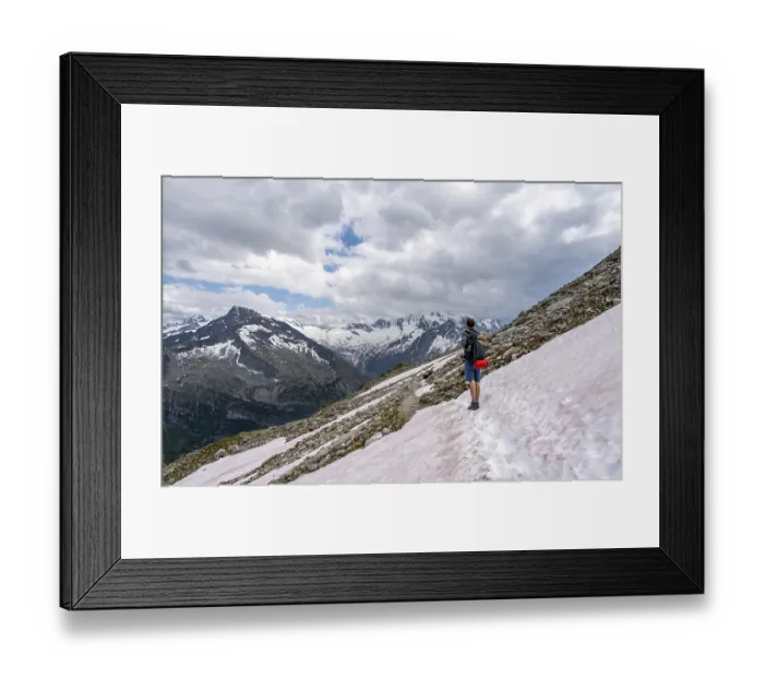 Framed Print : Mountaineer on hiking trail with snow