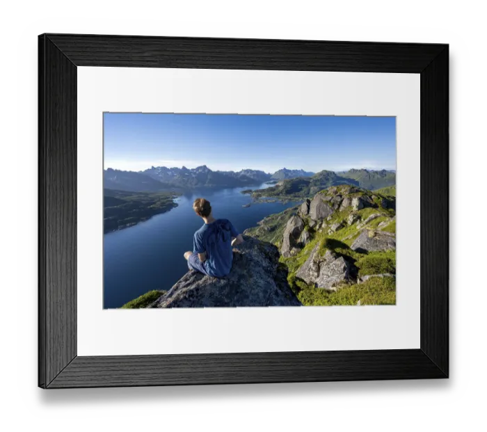 Framed Print : Mountaineer sitting on the summit of Dronningsvarden or Stortinden