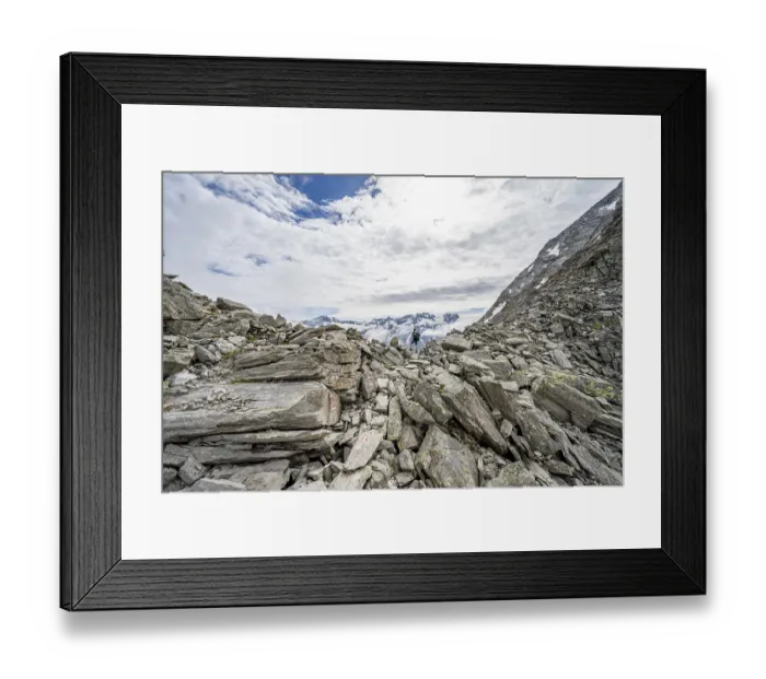 Framed Print : Mountaineer in a rocky saddle, Lapenscharte with view of mountain peaks