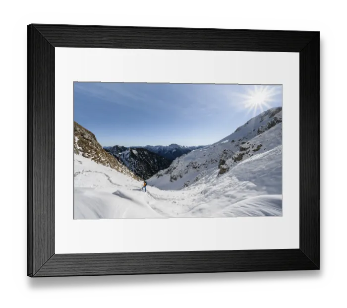 Framed Print : Mountaineer on hiking trail in winter with snow