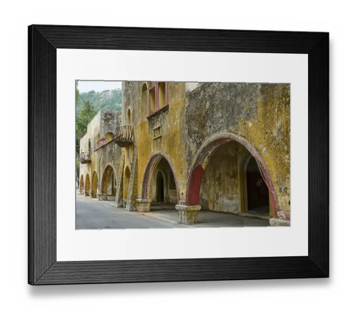 Framed Print : Street with dilapidated yellow historic-style buildings characterised by arches Framed Print : Street with dilapidated yellow historic-style buildings characterised by arches