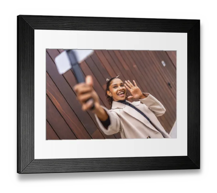 Framed Print : African american young female Content creator recording a new vlog using phone in the city