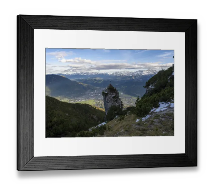 Framed Print : Rocky peak with summit cross, view of Garmisch-Partenkirchen and mountain panorama