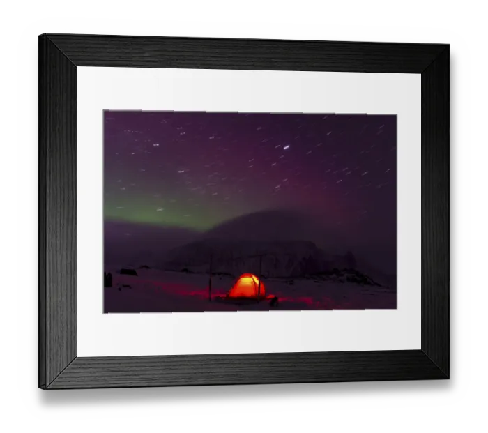 Framed Print : Northern Lights (Aurora borealis) and star trails above an illuminated tent in the valley Stuor Reaiddavaggi