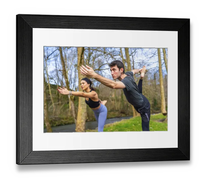 Framed Print : Yoga teachers performing a balancing asana by a river in the forest Framed Print : Yoga teachers performing a balancing asana by a river in the forest