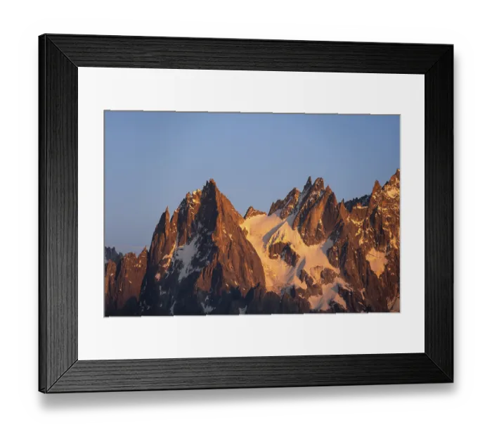 Framed Print : Rocky pointed mountain peaks at sunset