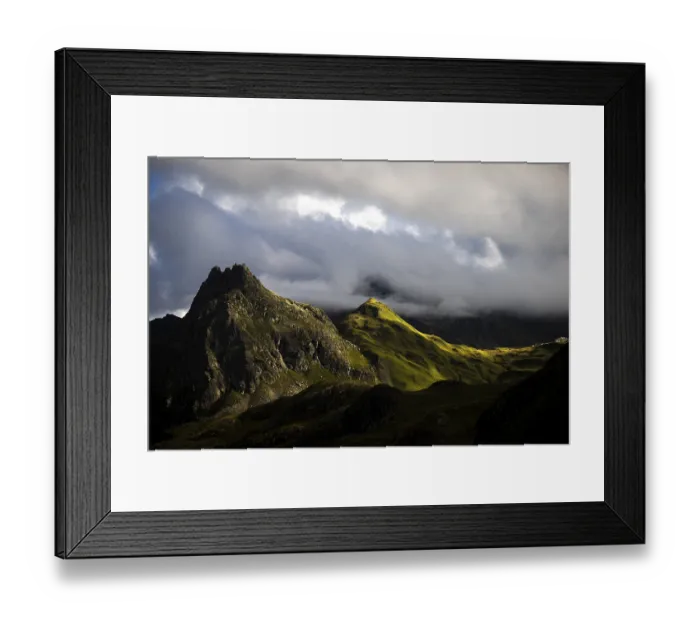 Framed Print : Grassy mountains with light mood and threatening clouds