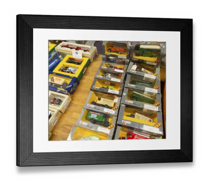 Framed Print : Boxes of Corgi model trucks, vans and other vehicles on display at auction