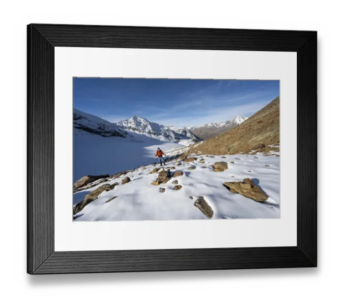 Framed Print : Mountaineer on a hiking trail with snow