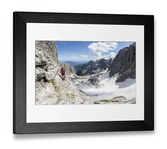 Framed Print : Mountaineer with helmet in a secured via ferrata