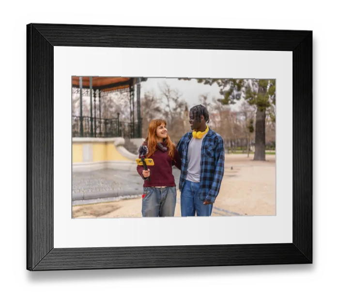 Framed Print : Two young content creators walking and talking in a park Framed Print : Two young content creators walking and talking in a park