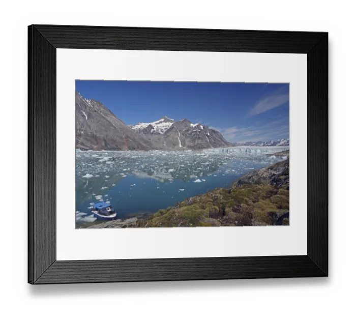 Framed Print : A small boat moored on a clear fjord in front of an impressive mountain and glacier landscape