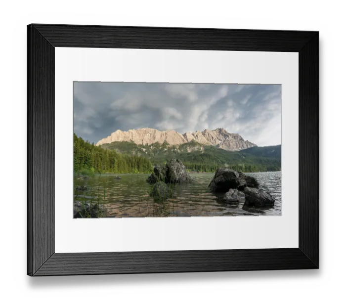 Framed Print : Rocks on the shore, Lake Eibsee lake in front of Zugspitze massif with Zugspitze Framed Print : Rocks on the shore, Lake Eibsee lake in front of Zugspitze massif with Zugspitze