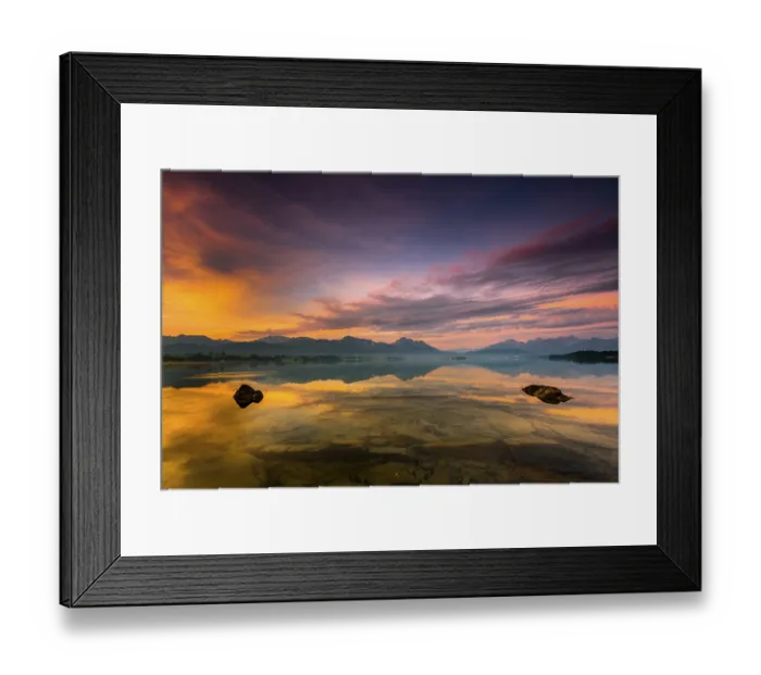 Framed Print : Forggensee with reflection of the cloudy sky and the Allgaeuer mountains in the background at sunrise Framed Print : Forggensee with reflection of the cloudy sky and the Allgaeuer mountains in the background at sunrise